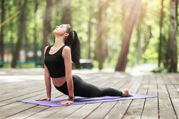 Doing yoga on an exercise mat.