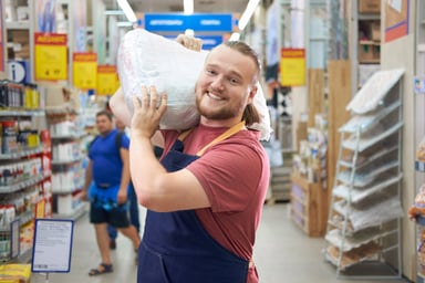 man carrying bag at hardware store