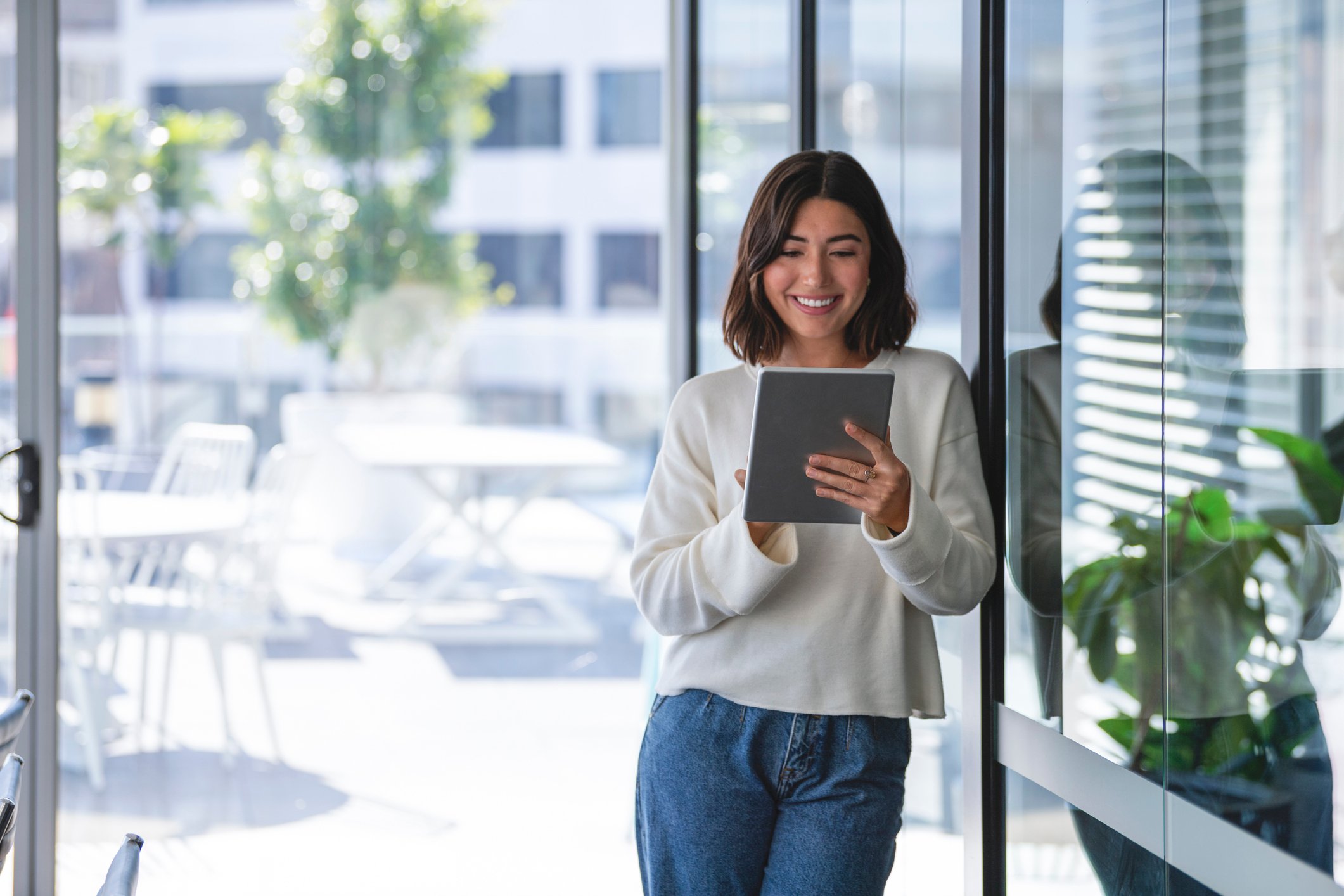 investor smiling tablet outdoor background