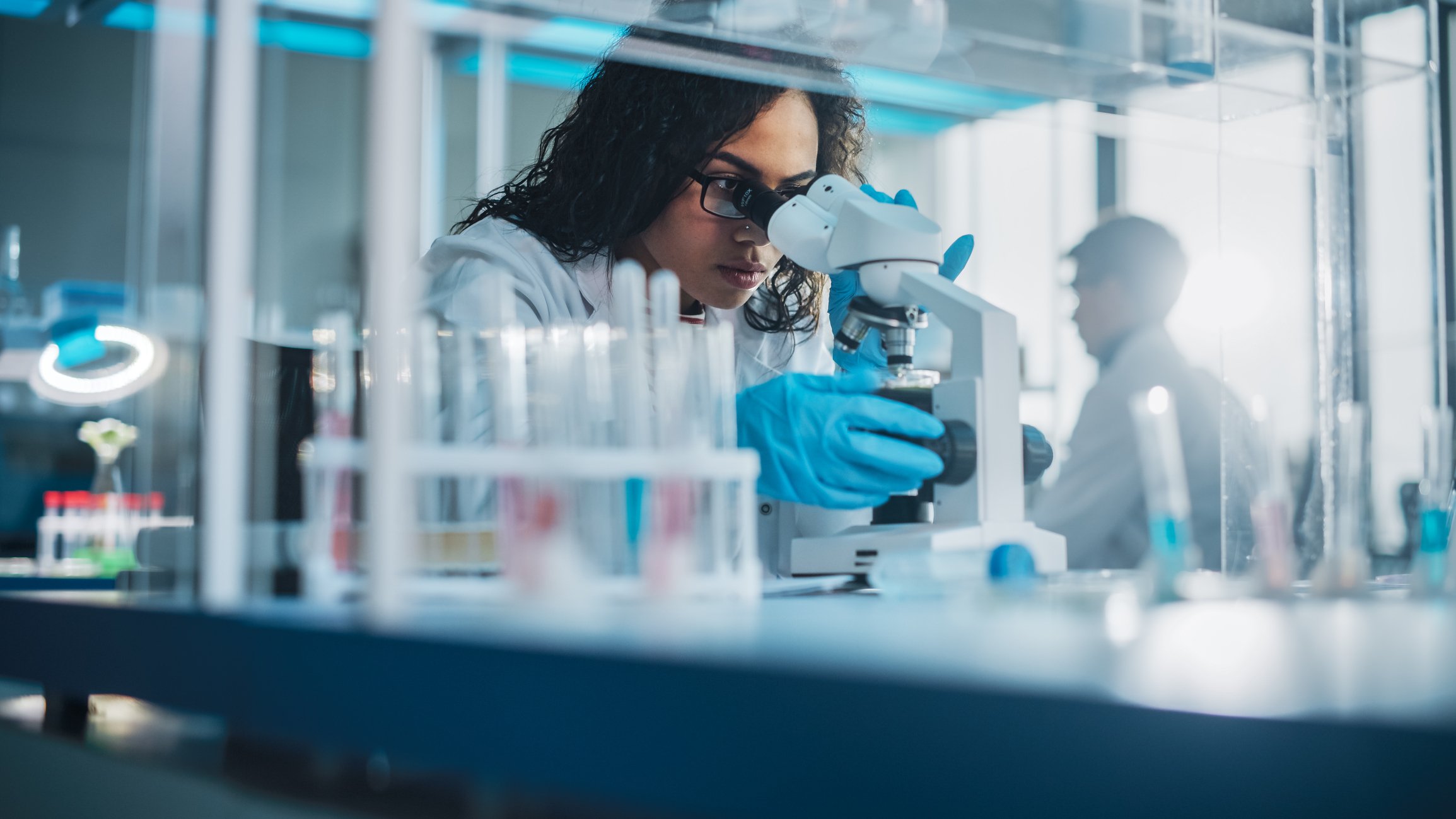 Scientist Looking through a microscope