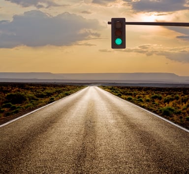 A green light before a long rural road