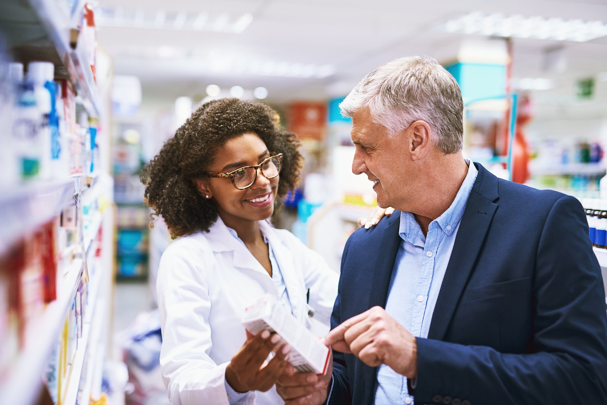 Pharmacist helping a customer.