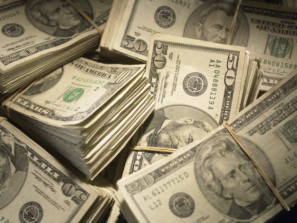 Several stacks of $20 and $50 bills.