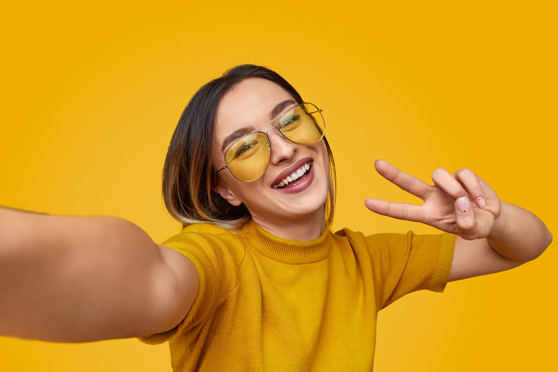 A person takes a selfie with a camera.