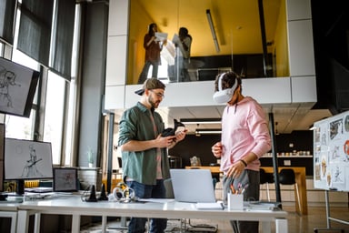 coworkers wear VR headsets in office setting