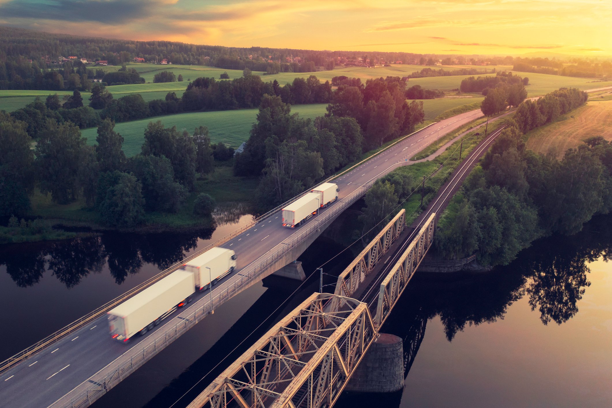 trucks driving over a bridge shipping