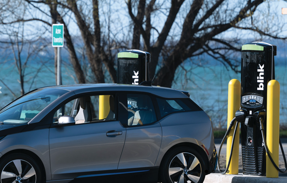 EV at Blink charger with lake in background. 