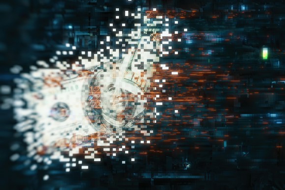 A digital image of a dollar dissolves into colored pixels.