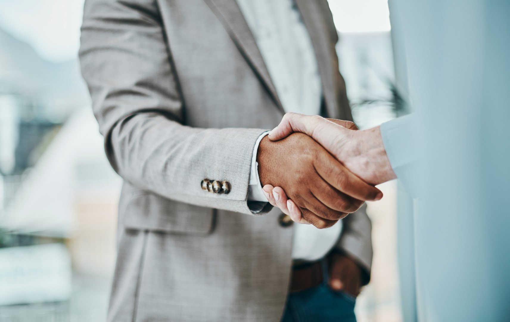 haking hands in a modern office deal