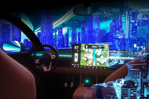 Interior of electric vehicle with large computer monitor.