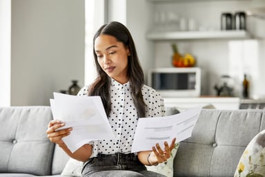 investor inspects papers on a couch