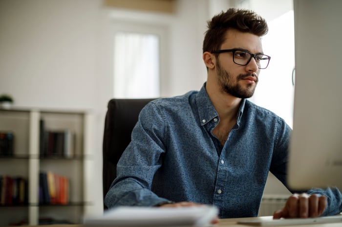 A person looking at a computer.