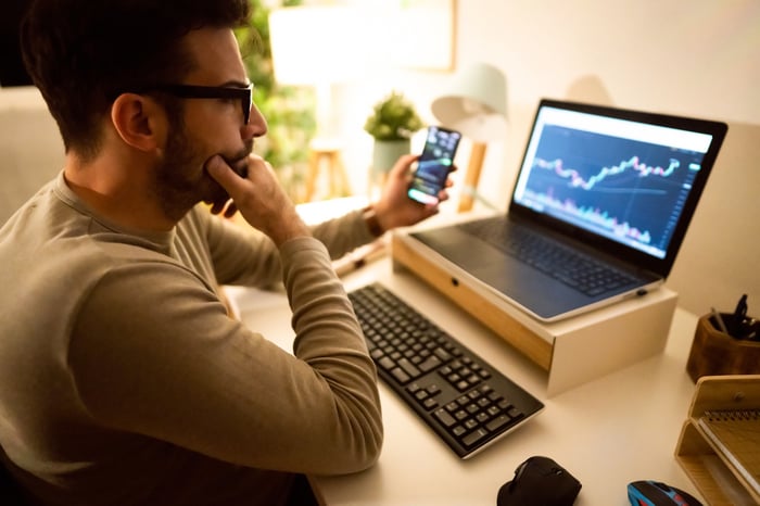 A person looking at a chart on a computer. 