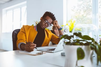 Person sitting at desk thinking
