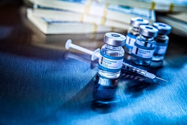 Coronavirus vaccine vials in hospital with money