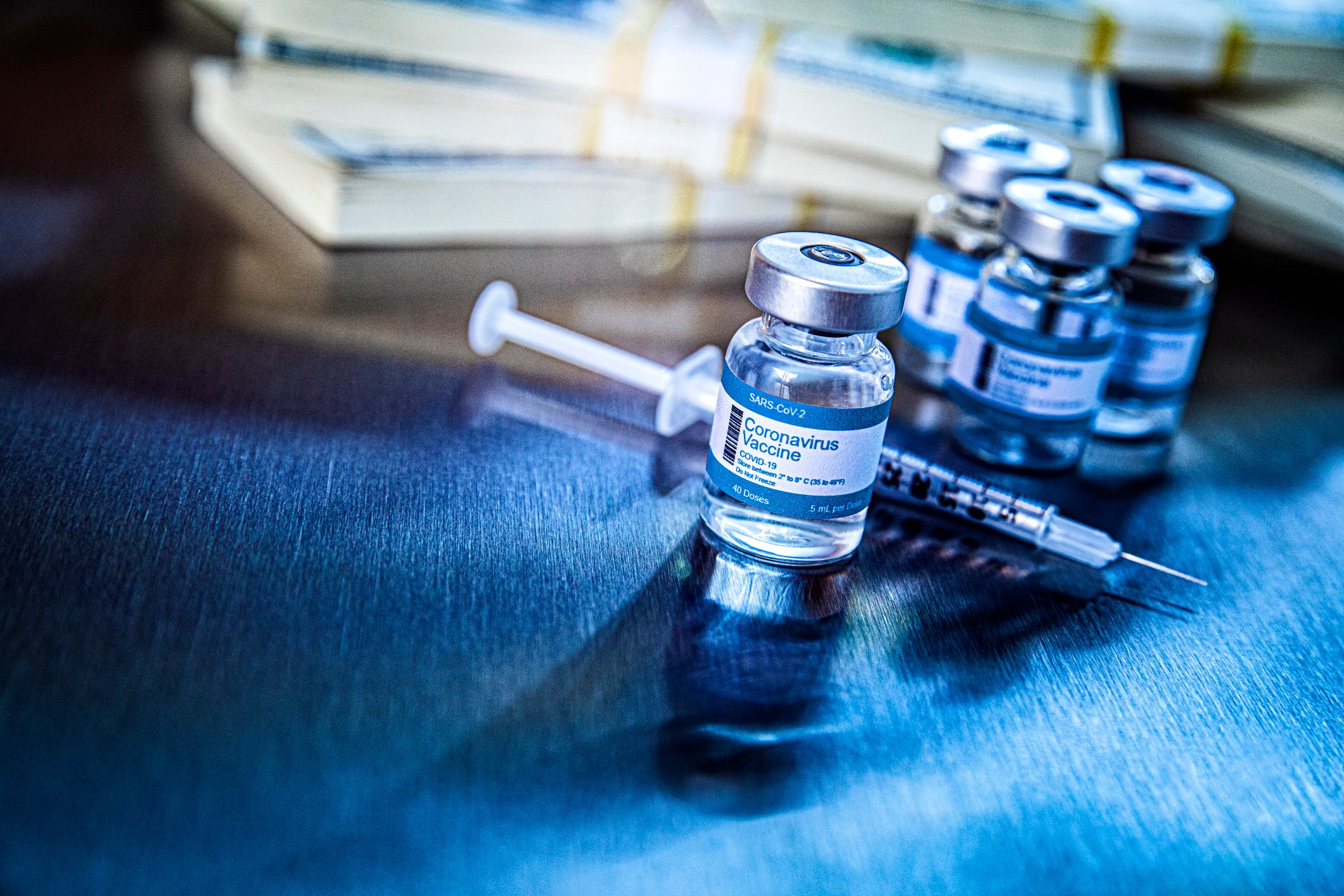 Coronavirus vaccine vials in hospital with money