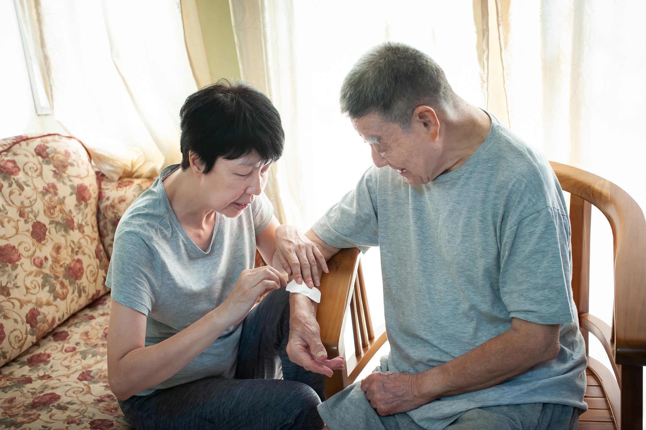 Elderly person assisting a peer