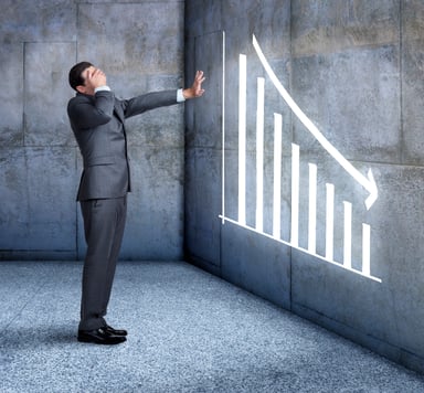 man staring at a downward graph