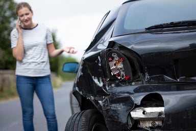 auto insurance car damage crash woman on phone