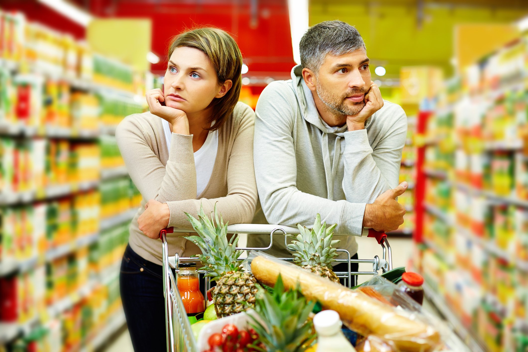 Two people shop at a grocery store.