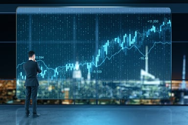 A person looking at a visual of a stock chart.