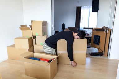 tired moving unpacking boxes new home