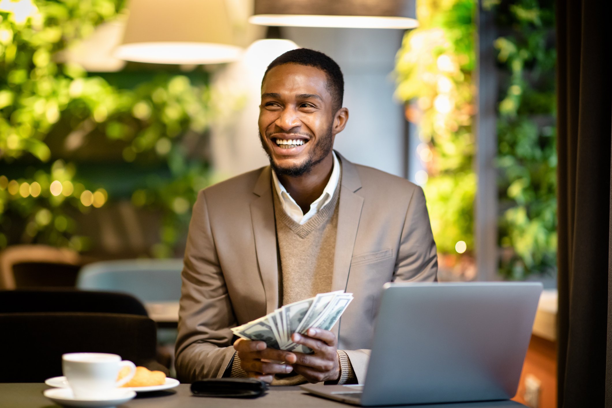Getty - happy with cash money laptop