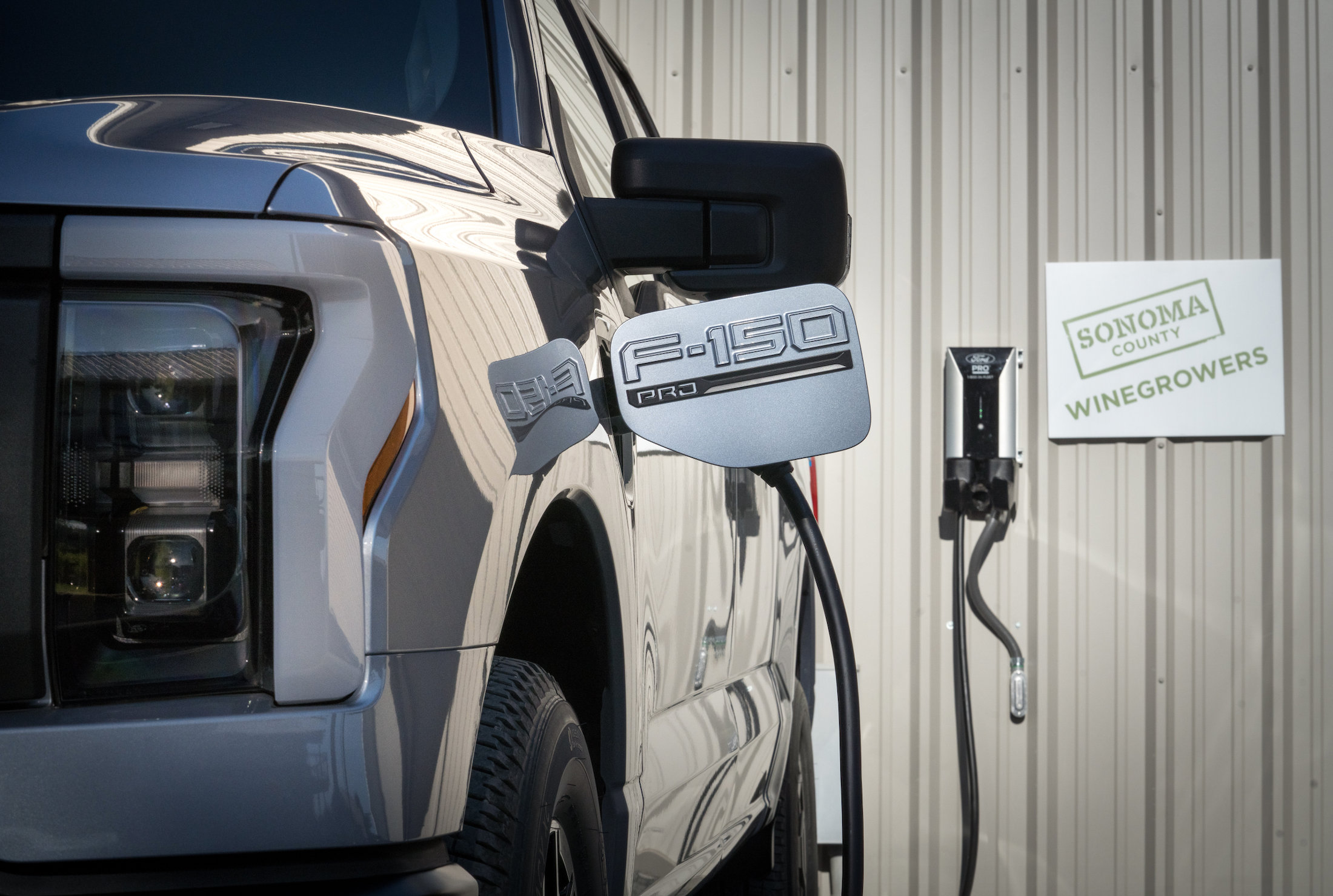 Ford F-150 Lightning plugged into charger.