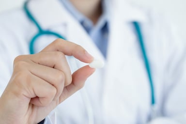 Doctor holding a pill
