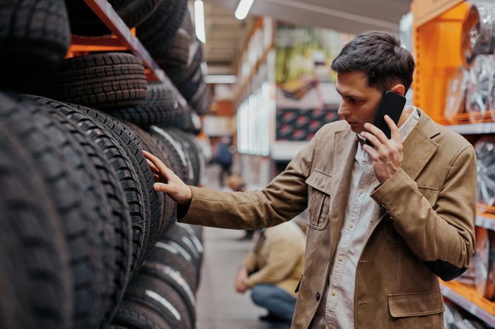 A customer shops for car tires.