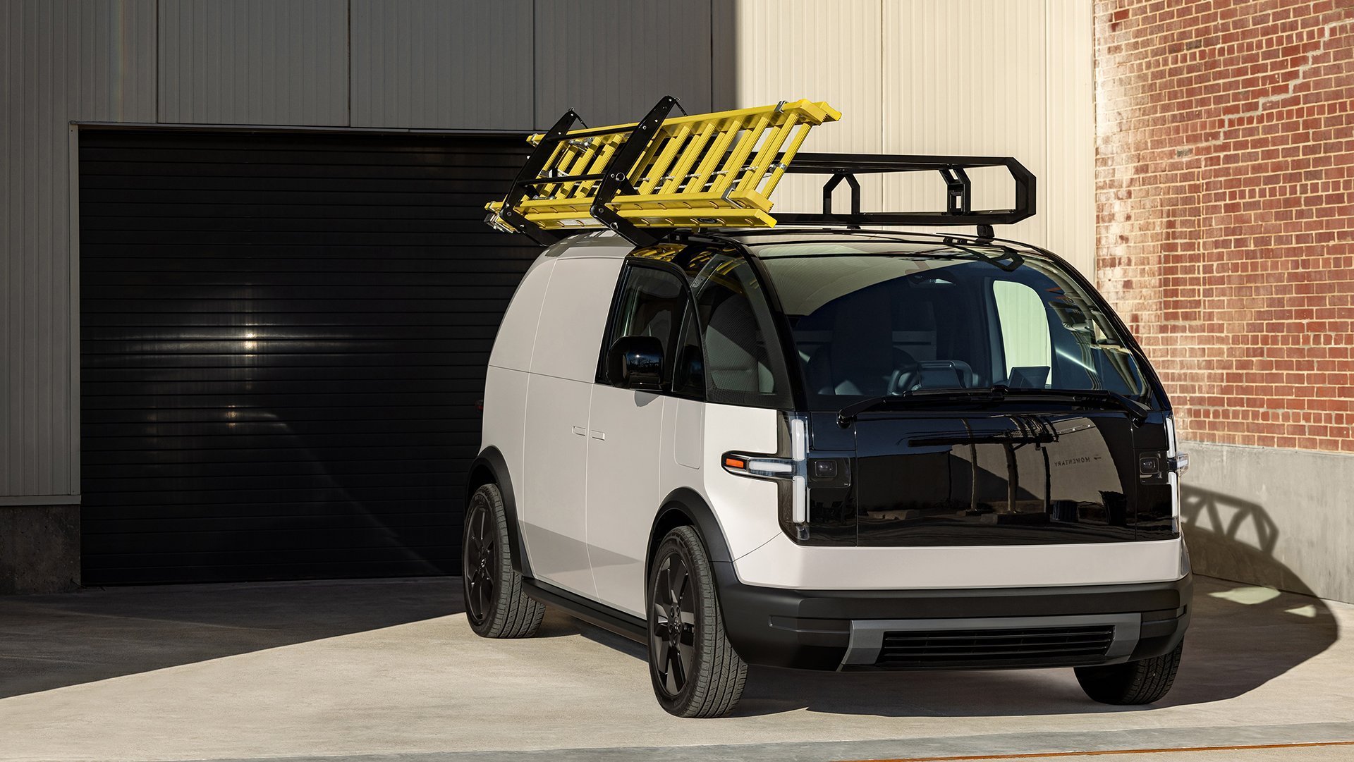 White Canoo utility van with ladder on rack. 