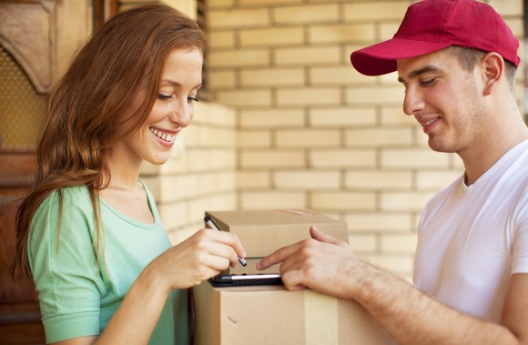 A person signs for a package.