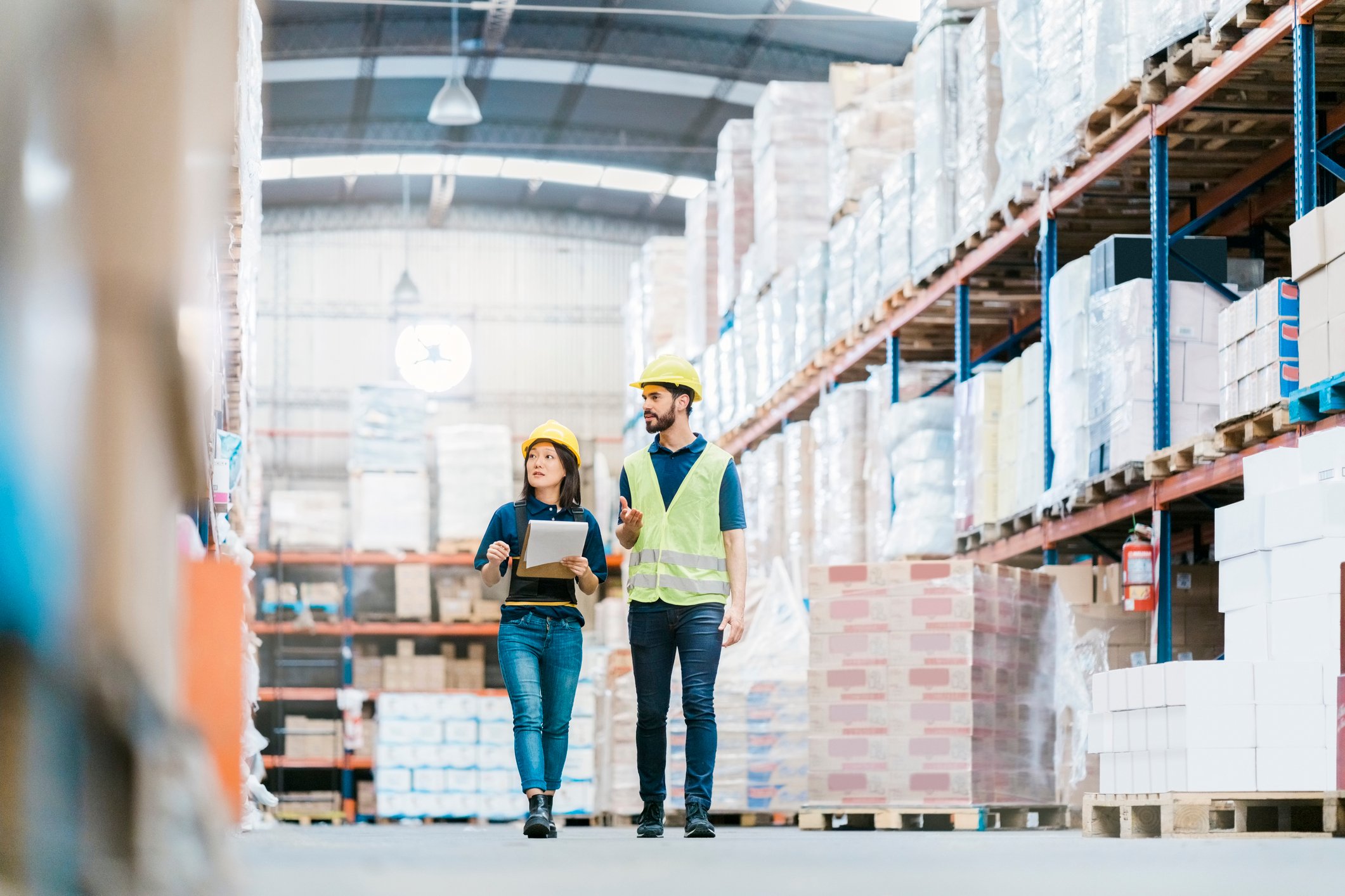 Two employees working at a warehouse.