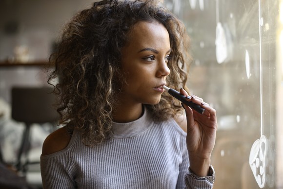 Person using an electronic cigarette.