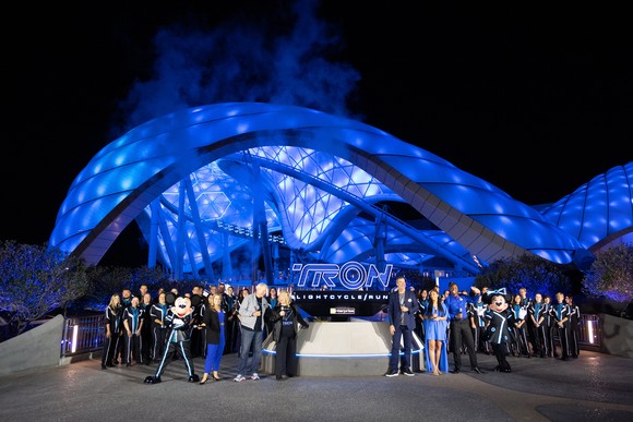 Disney and Tron personalities in front of the Tron Lightcycle Run on Tuesday night for a media event.