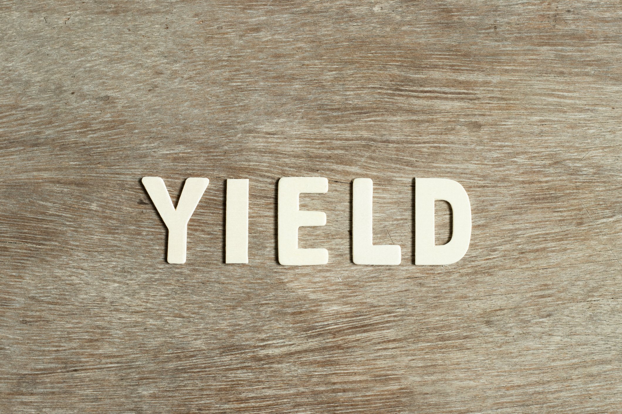 yield in metal letters wood background