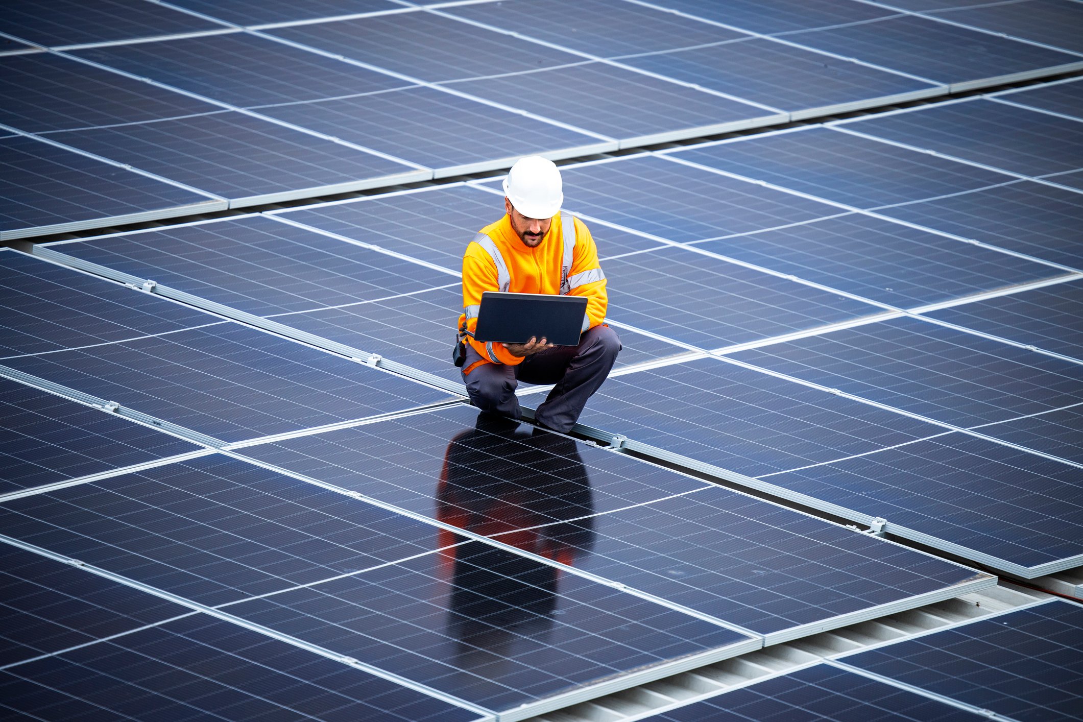 Engineer inspects solar panels.