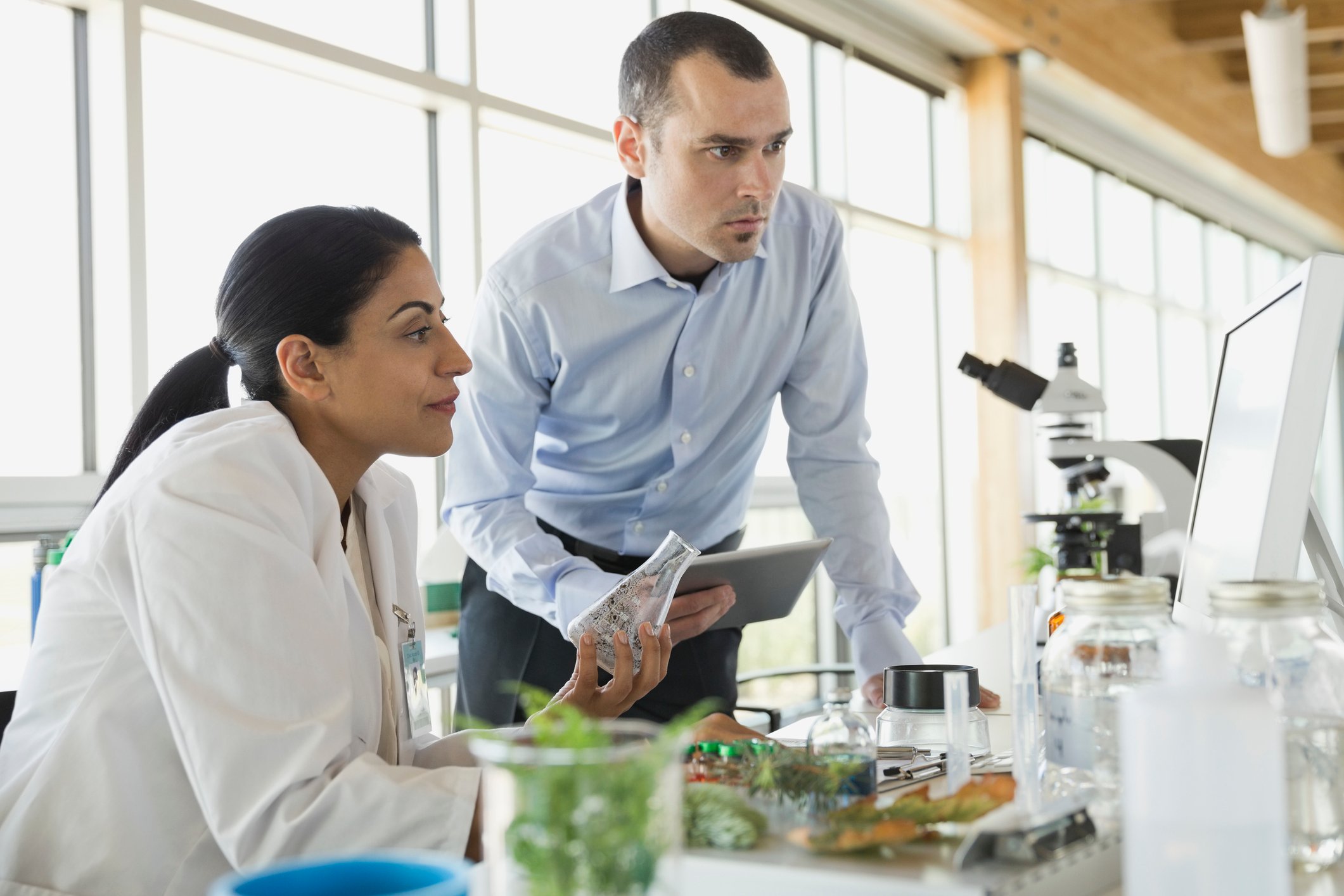 two scientists review data in lab bench