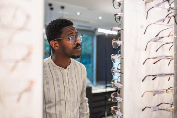 Person trying on a new pair of glasses.