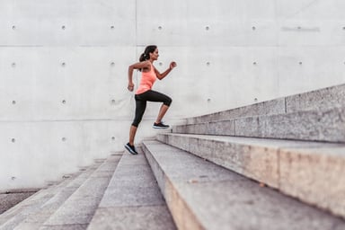 woman running up outdoor stairway