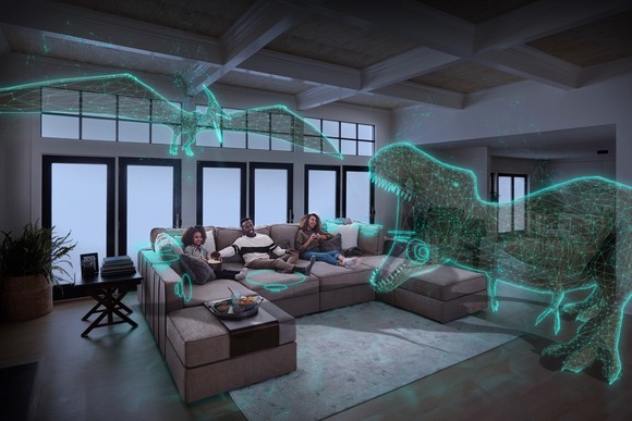 A family apparently enjoying a dinosaur movie on their Lovesac Sactionals.