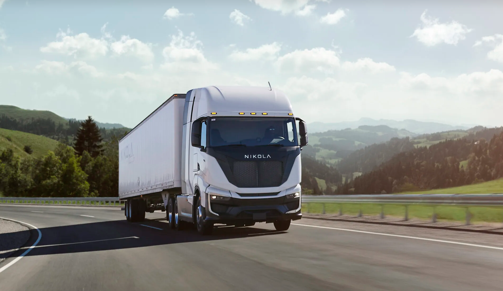 Nikola Class 8 heavy truck driving down scenic highway.