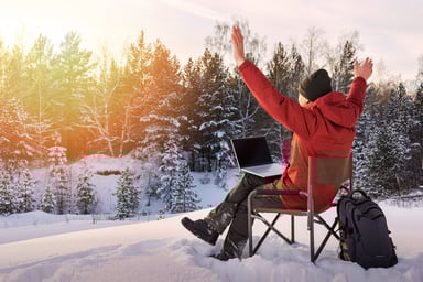 working on a laptop in winter forest