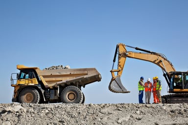 Mining equipment and personnel at a site