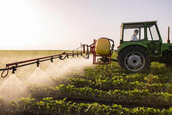 Farm equipment spraying crops with water or pesticides.