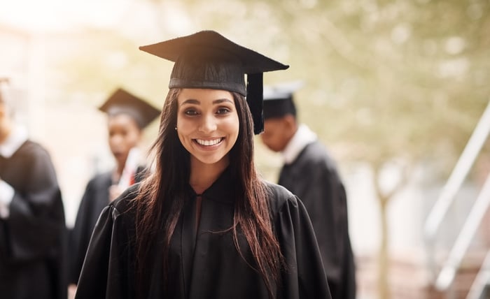 Someone wearing a black graduation cap and gown.