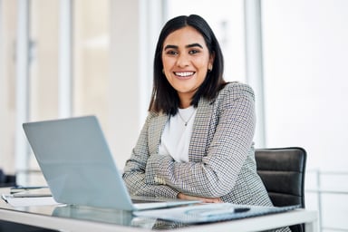 A businessperson works on a laptop.