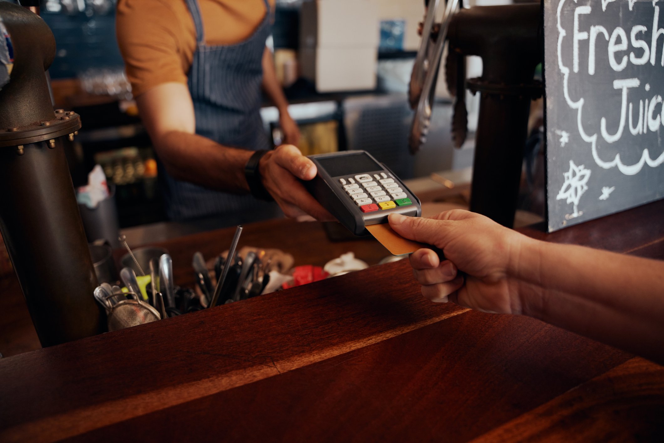 Buyer using credit card to pay for item at store