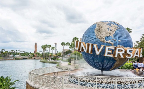 The entrance to Universal Studios Florida, with the Islands of Adventure lighthouse in the background.