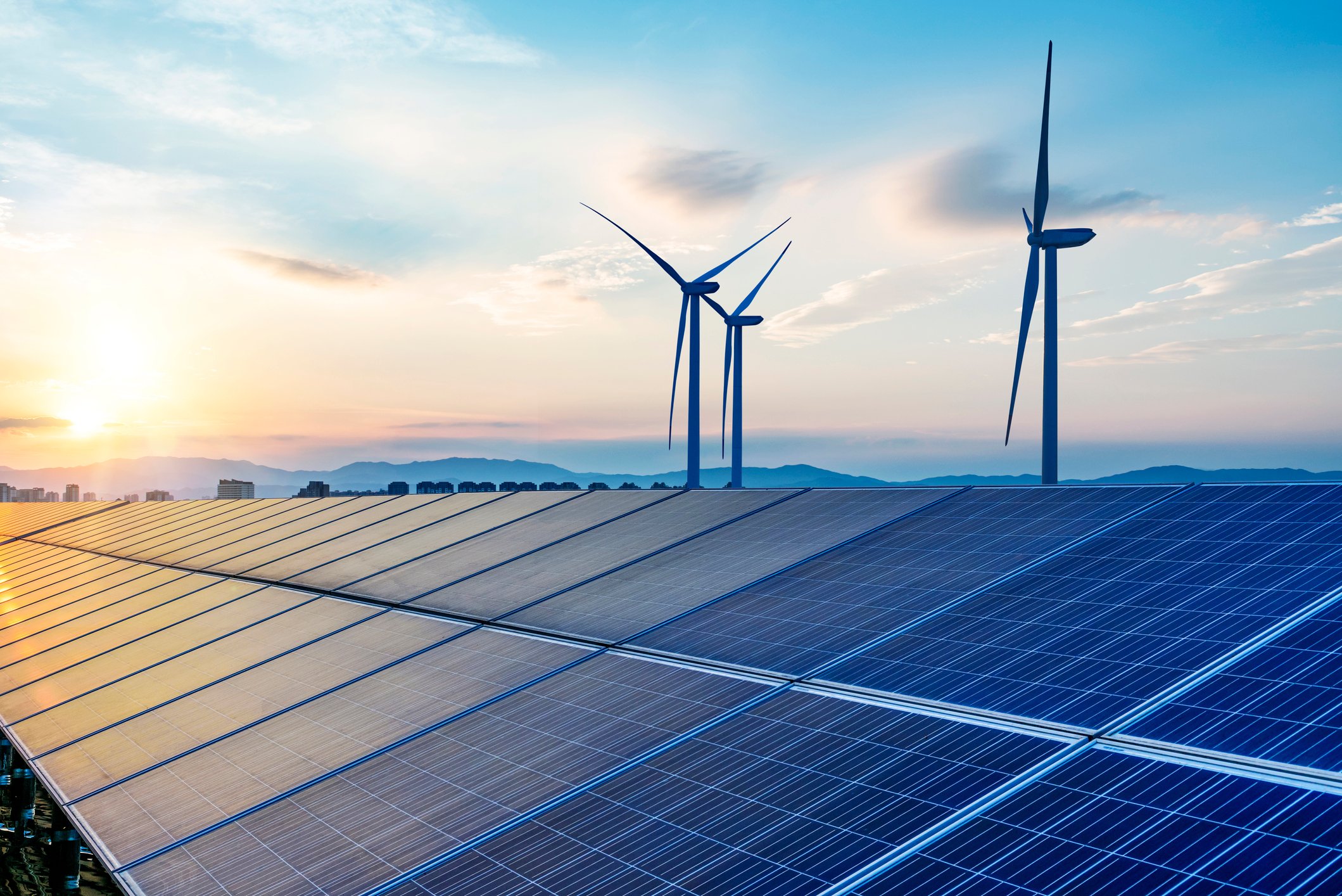 Wind turbines and solar panels in a field.